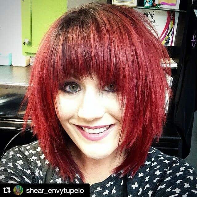 Red bob with natural roots and angled bangs