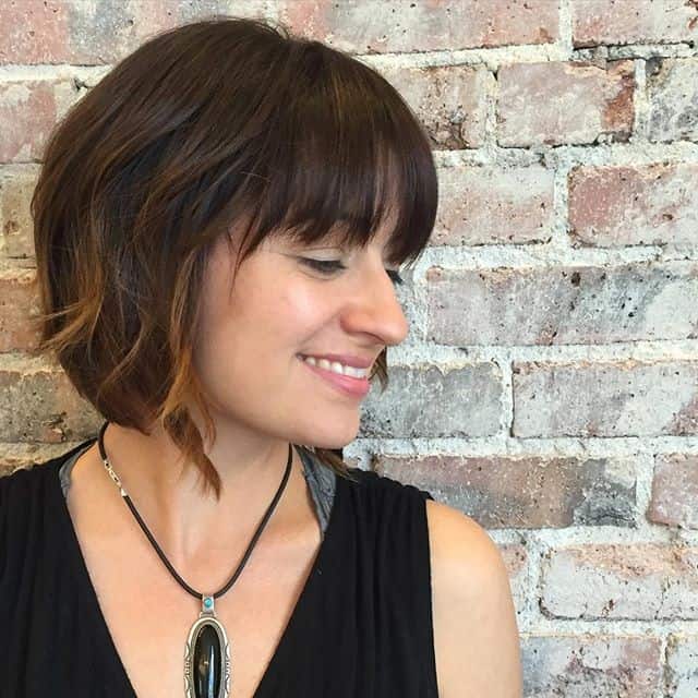 Dark brown bob with light brown highlighted tips and bangs