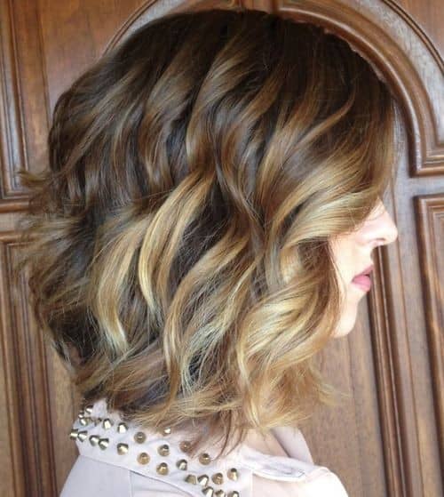 Wavy warm brown graduated bob with blonde chunks