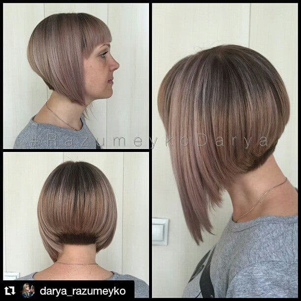 Light brown and grey angled short bob with blunt bangs and short and tapered neckline