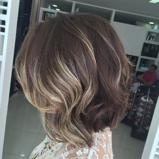 Slightly wavy medium length brown bob with blonde highlights