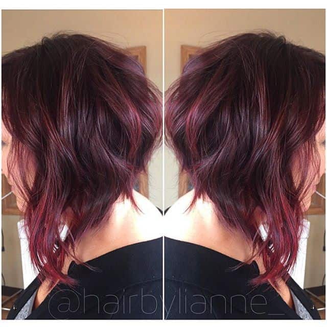 Deep red with lighter red highlights and long layers in front messy bob