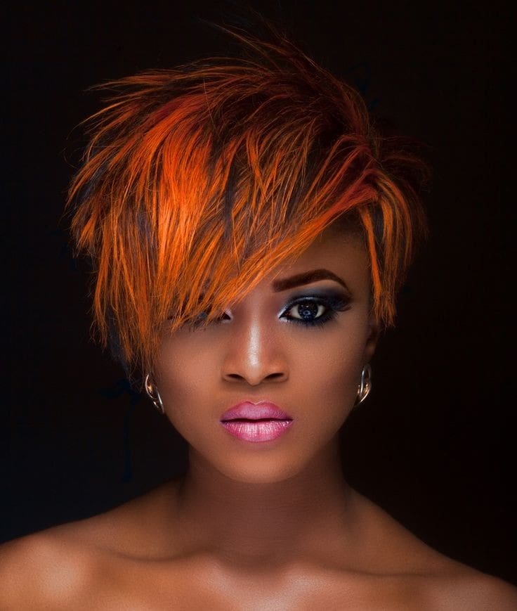 Short and spiky cut with bright orange hair color