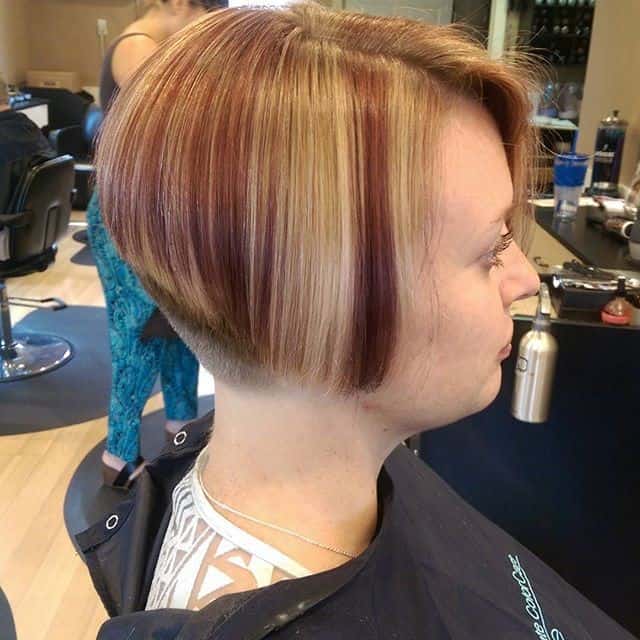 Blonde and brown stacked bob with clipper cut neckline