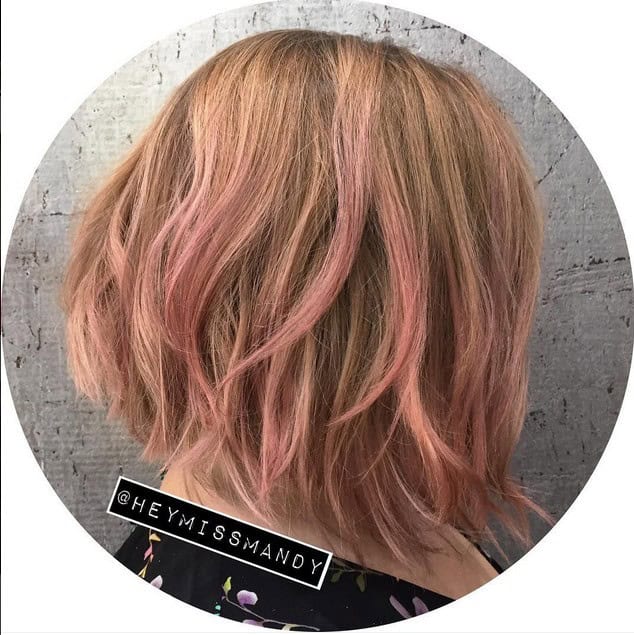 Wavy graduated balayage bob with soft pink streaks