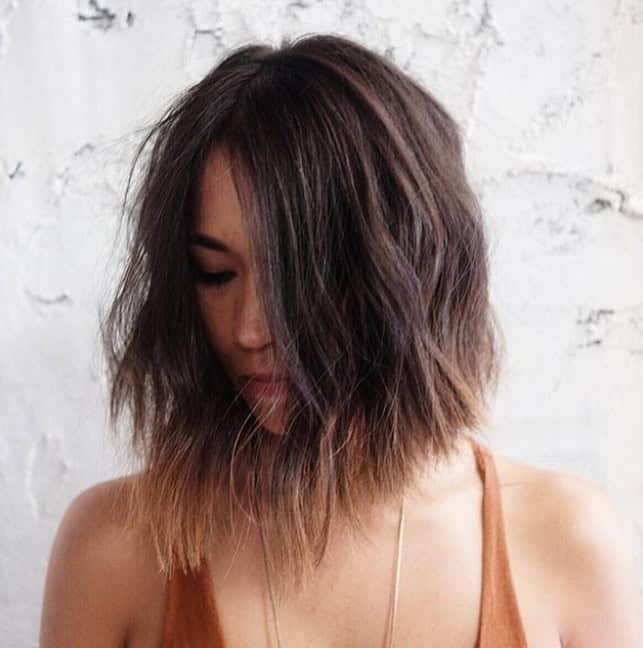 Asymmetrical choppy brunette bob with light brown ends (and middle part)