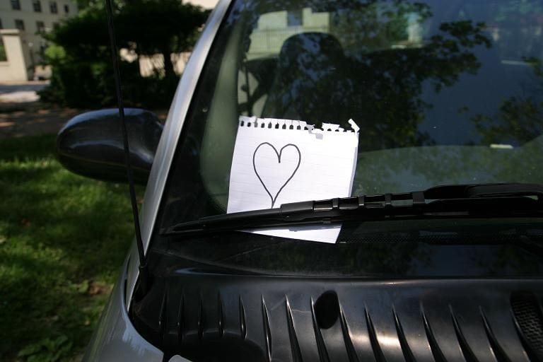 Leave a love note on his car.