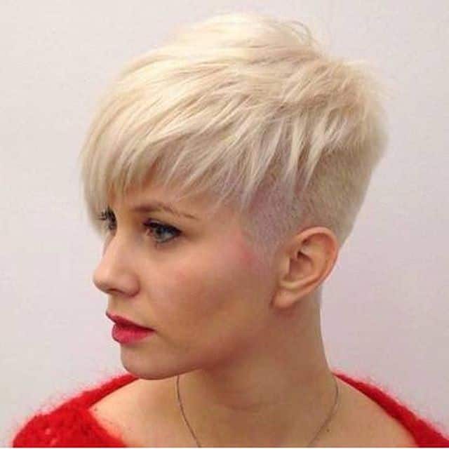 Platinum pixie with buzzed sides and choppy layered bangs