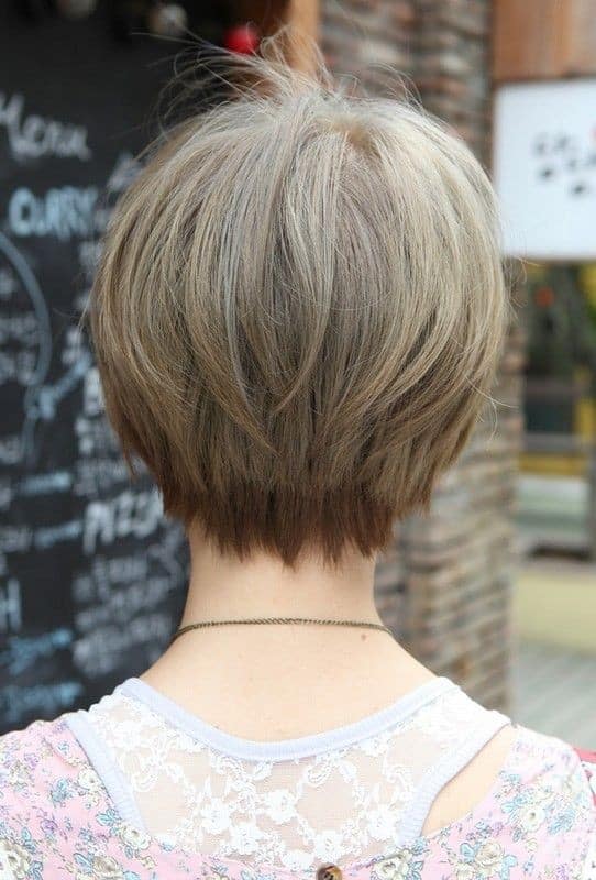 Short haircut with heavy layers and tapered neckline for women over 50