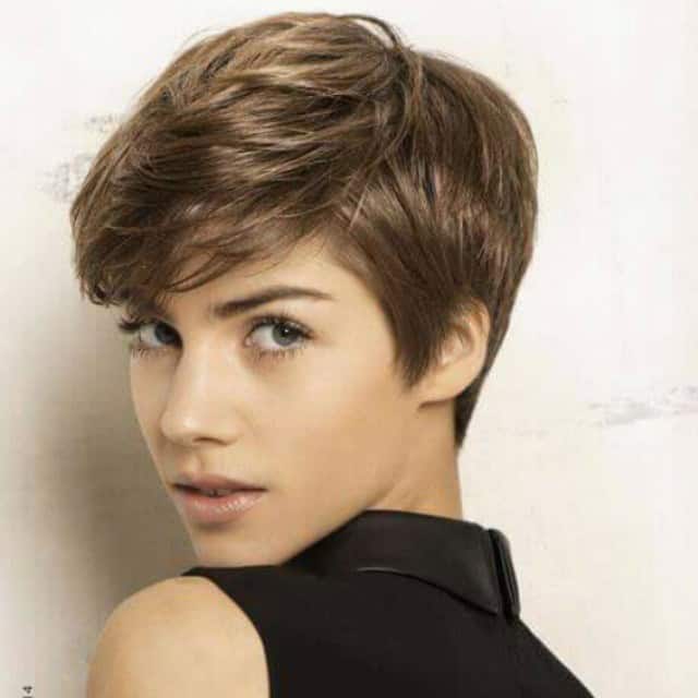 Pixie with side part and brushed over layered bangs