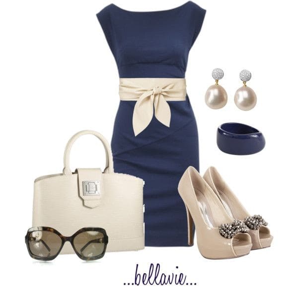 Navy fitted dress with a cream belt and matching patent leather pumps