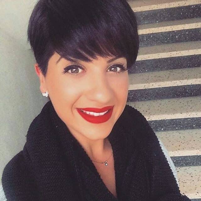 Sophisticated jet black pixie with long bangs