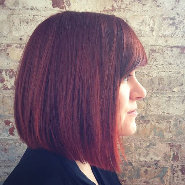 Dark brownish-red blunt bob with bangs