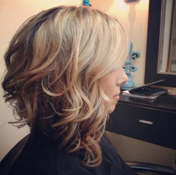 Stacked bob with curls, side-swept bangs and long sides