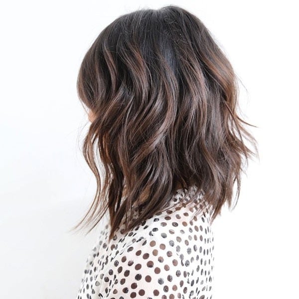 Dark brown wavy lob with light brown low lights and bangs