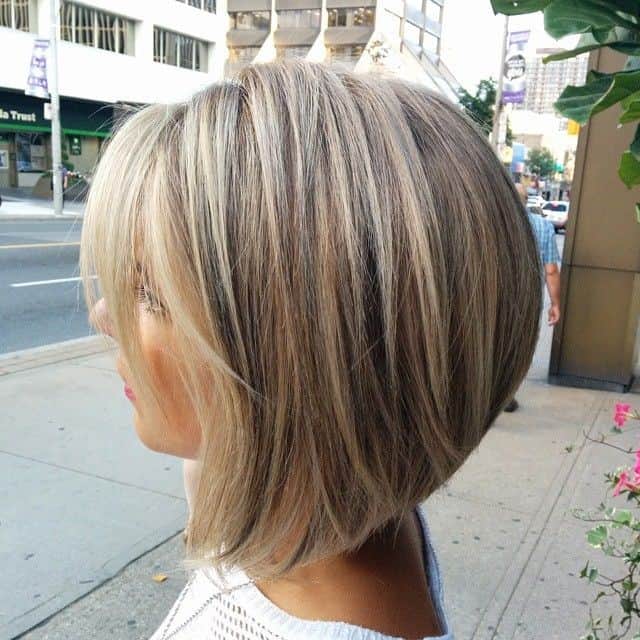 A-line bob for thick hair  with three colors and long blonde side-swept bangs