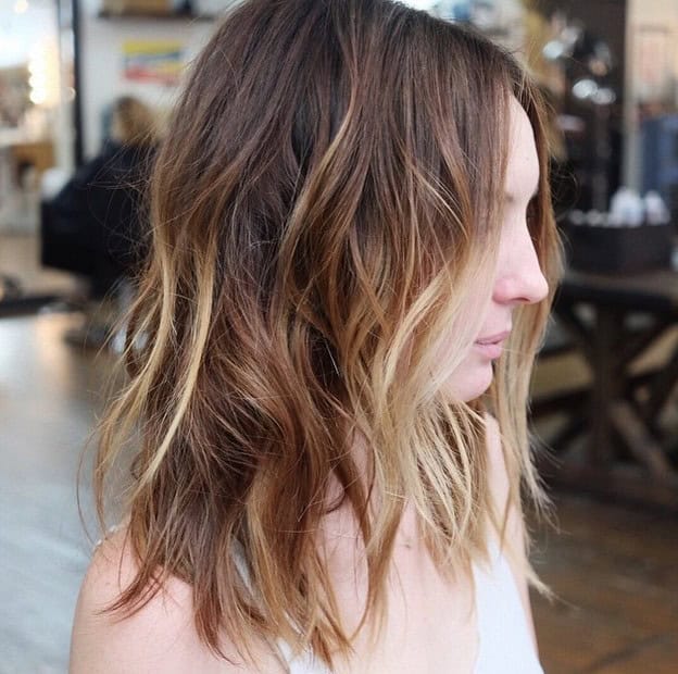 Long choppy lob with light blonde highlights (and a middle part)