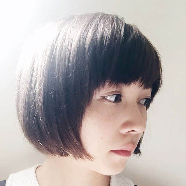 Black blunt chin-length bob with face-framing bangs and sides