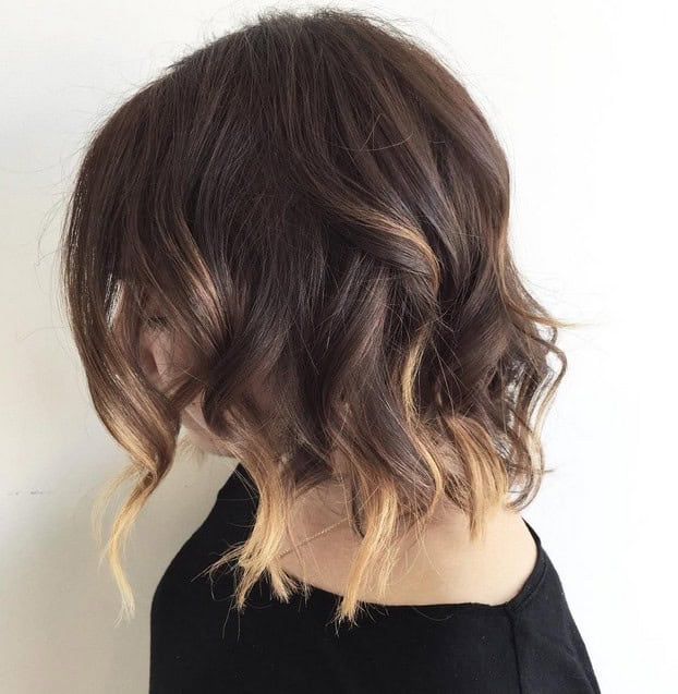 Dark brown wavy choppy bob with “barely there” blonde tips