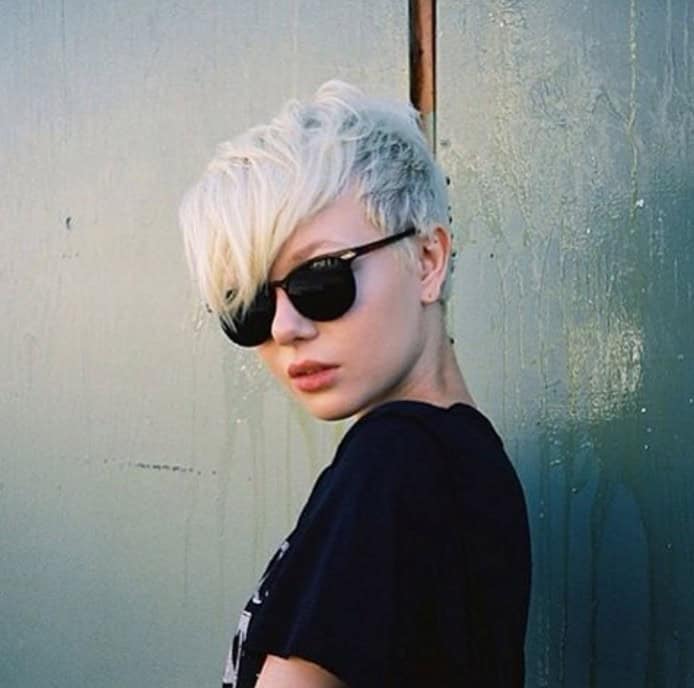 Platinum pixie with full bangs and natural roots