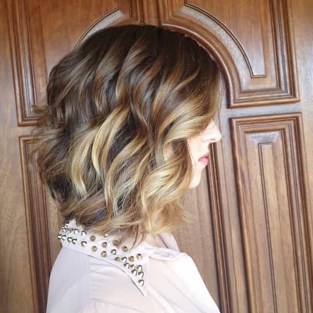 Wavy low-angled semi-short bob with blonde highlights